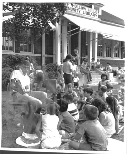 Black and white photo of Story hour on the front lawn