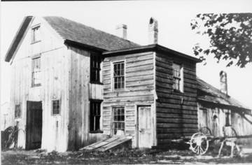 Black and white photograph showing Bill Thomas’ blacksmith shop which stood until the mid-1950’s at the corner of what is now Walt Whitman and Old Country Roads.