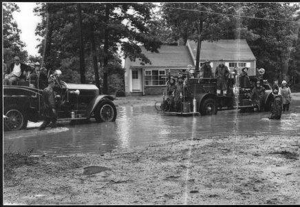 Black and white image of firefighters during flooding in the early 1950s