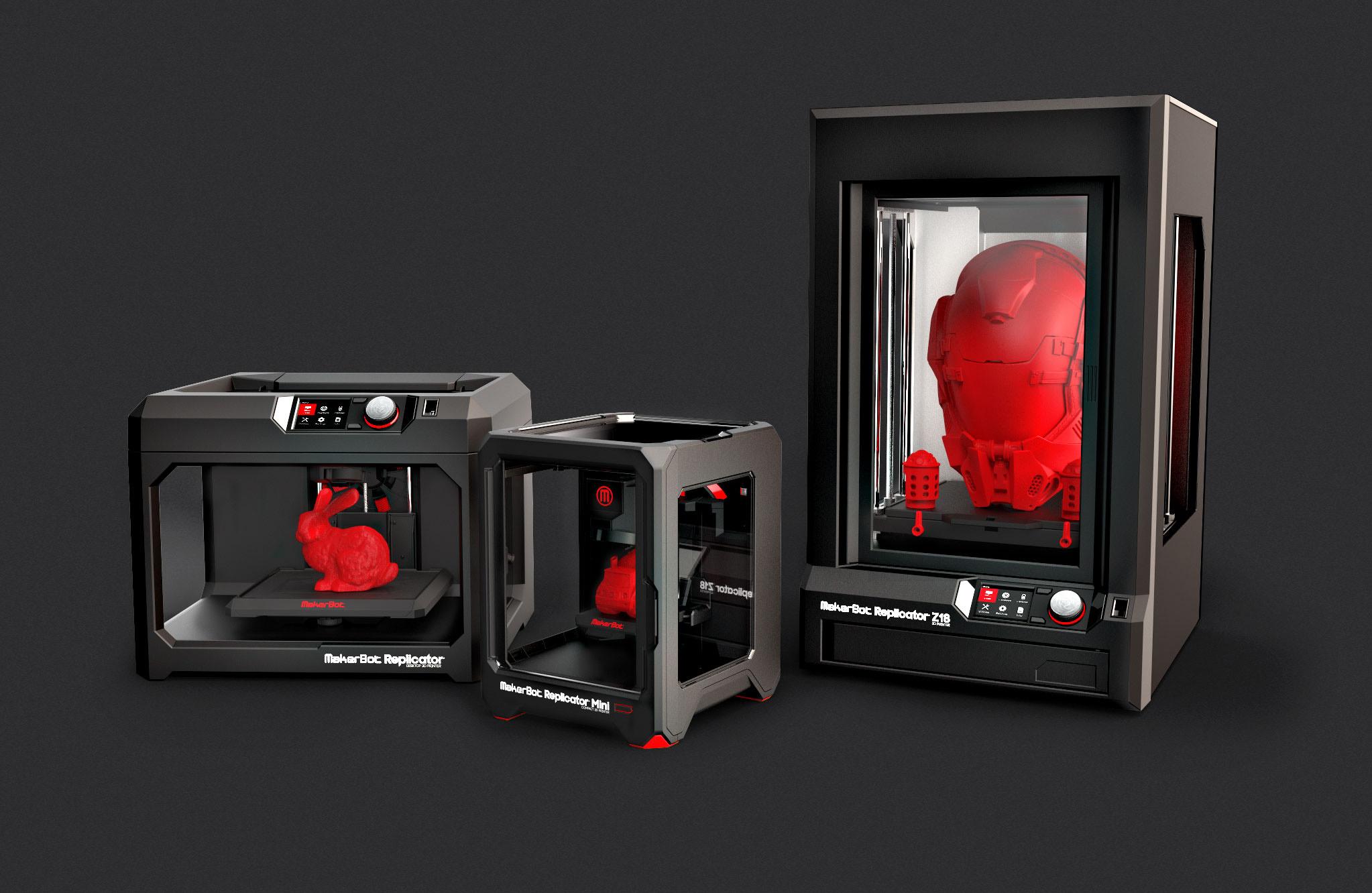 Three sizes of 3-D printers in the color black with red objects being printed. 