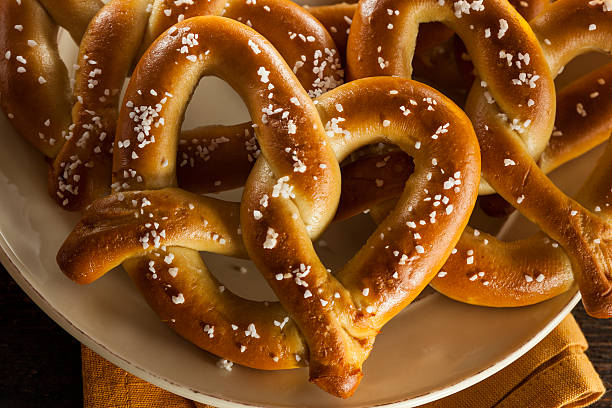 Image of a plate of homemade soft pretzels with coarse salt on the pretzels. 