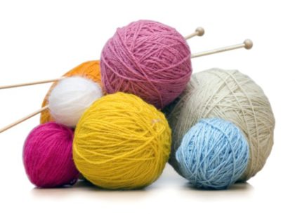 Multi-colored balls of yarn and two knitting needles