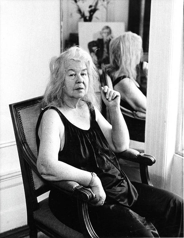 Photograph of Artist, Alice Neel sitting on a chair.