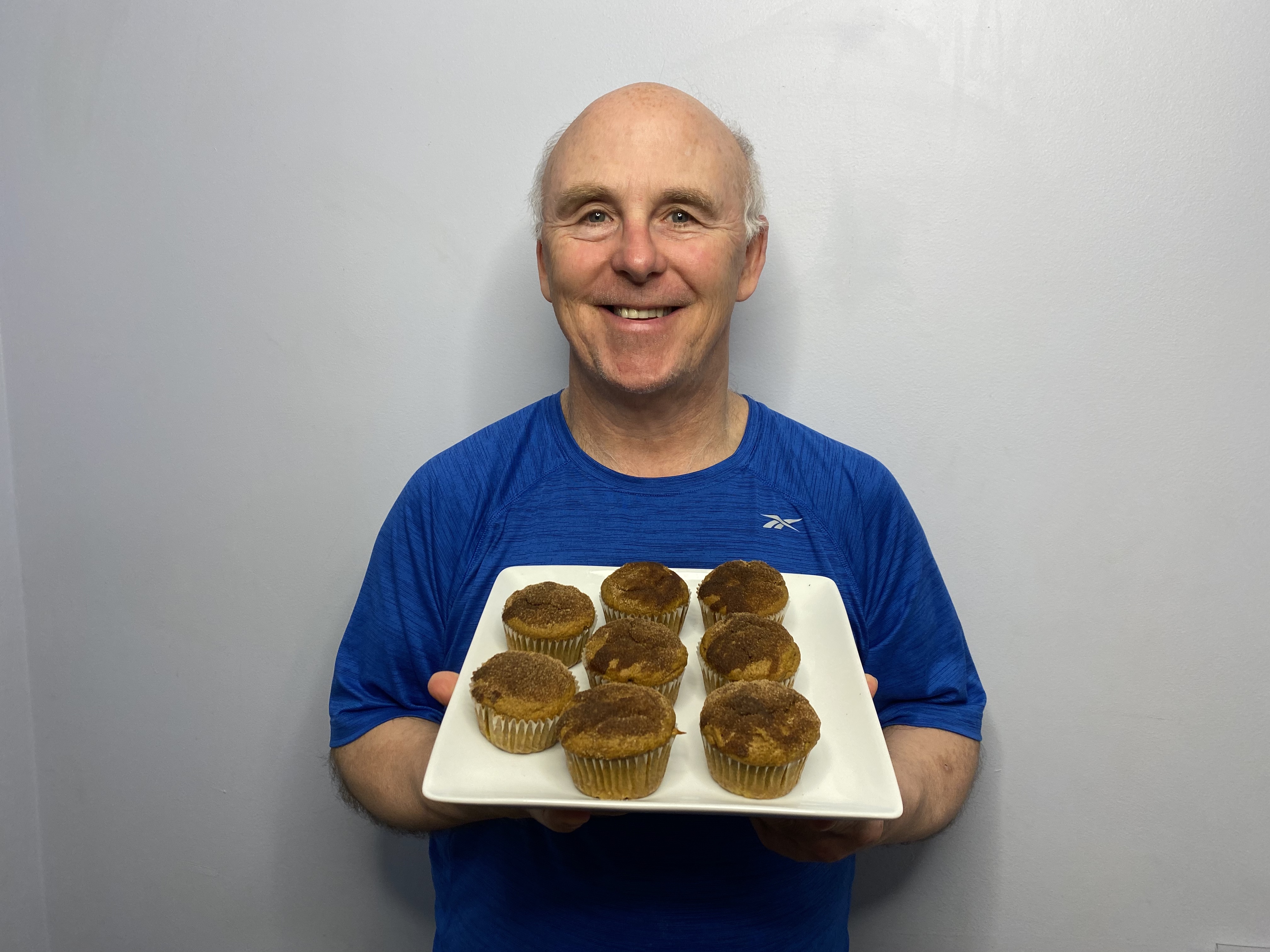 Image of Rob Scott holding a plate of muffins.