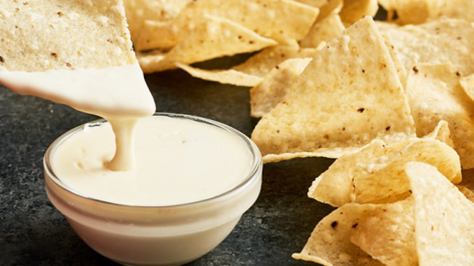Image of Tortilla chips with creamy queso. 