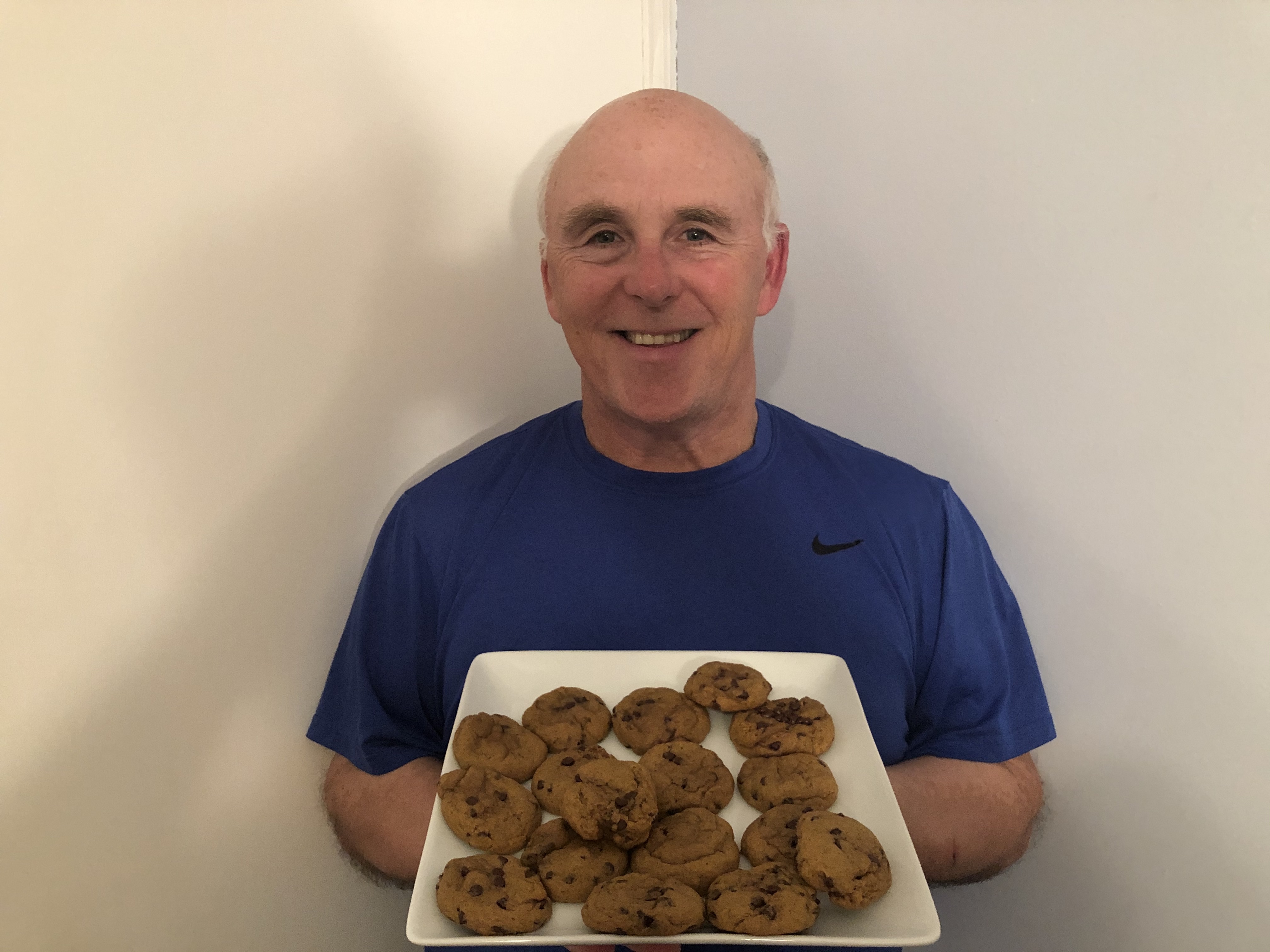 Photo of Rob Scott holding a tray of the pumpkin chocolate chip cookies.