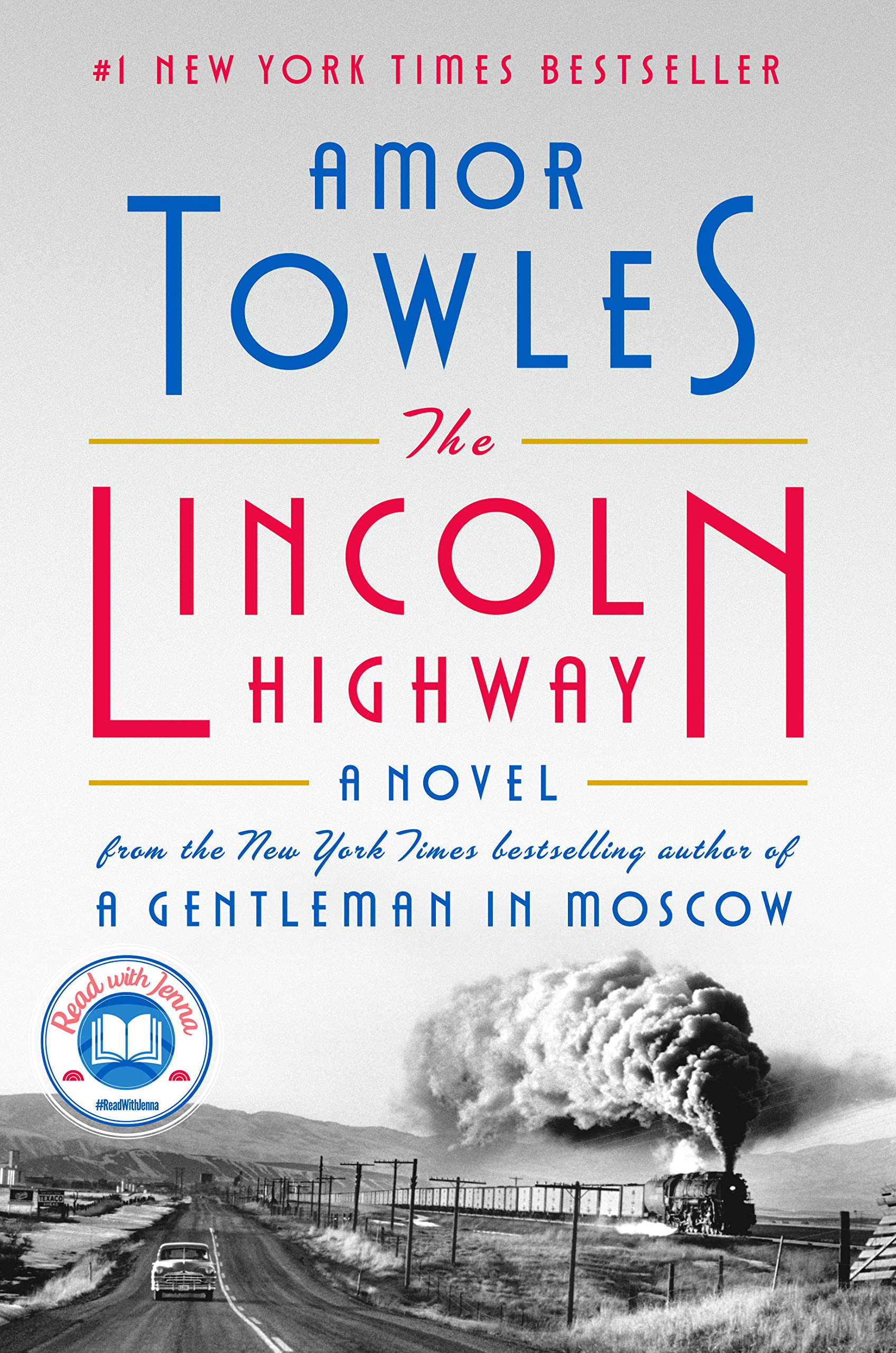 Image of the book cover, The Lincoln Highway featuring a black and white photo of an old fashioned car driving down a highway and a steam engine train along the rail road tracks heading in the same direction as the car.  