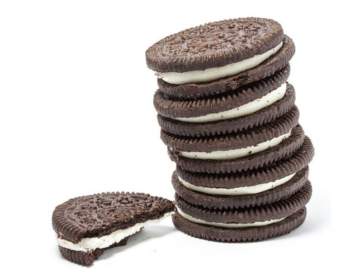 Image of a stack of Oreo cookies. One cookie is bitten in half. 