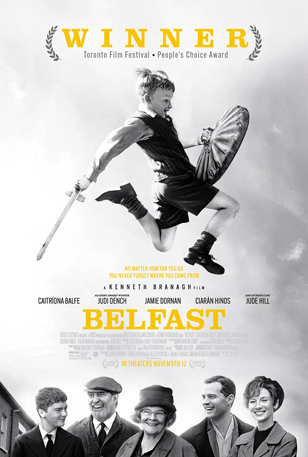 Black and white image of movie cover featuring a young boy leaping with a pretend sword and shield. At the bottom of the picture there are 5 people of varying ages smiling.