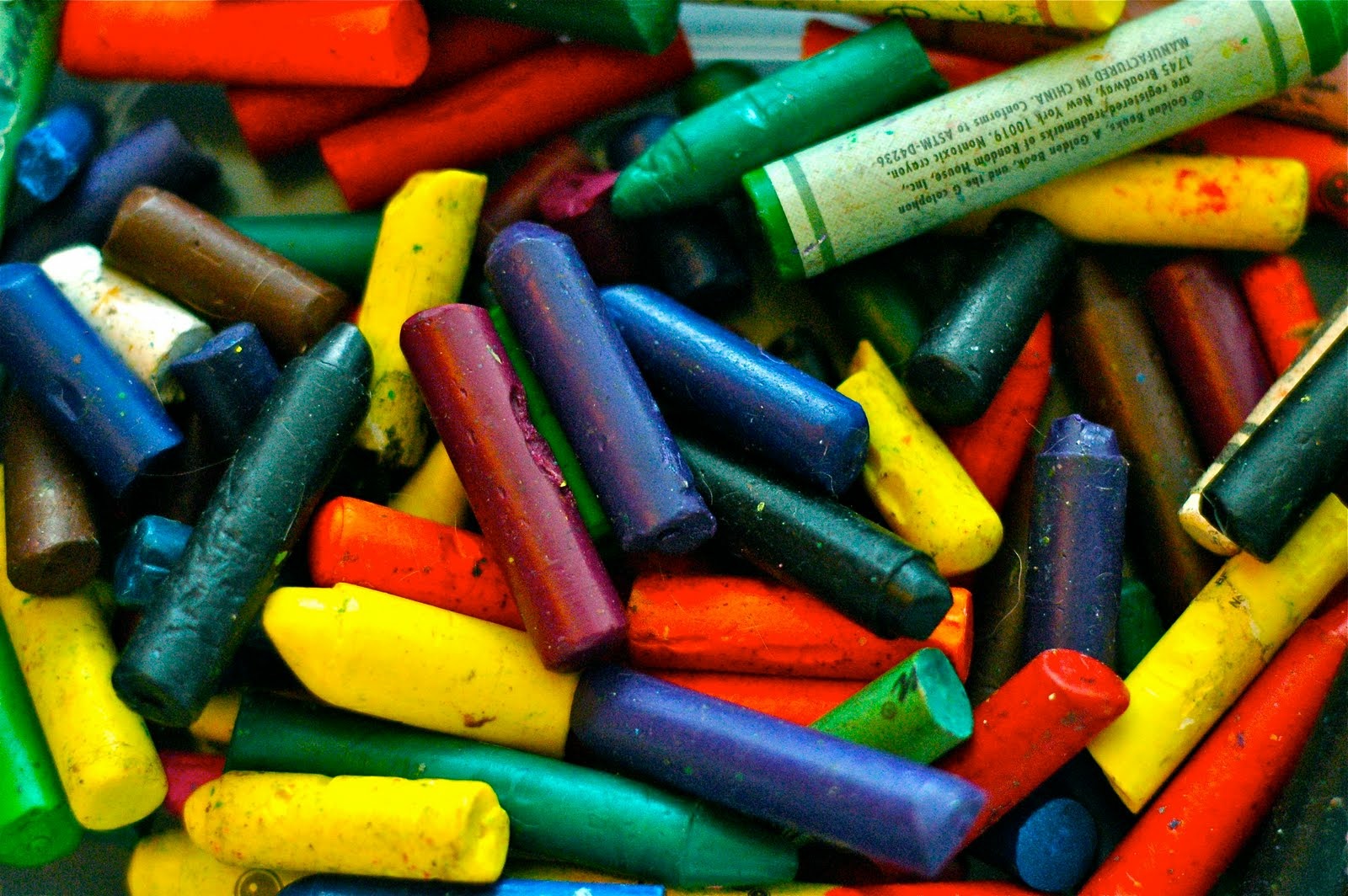 Image of all different colored broken crayons.