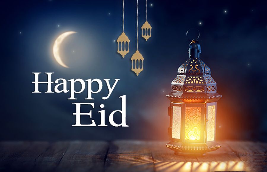 Image of a night sky with a crescent moon and a glowing gold lantern and smaller lanterns hanging in the background. The words "Happy Eid" spelled out. 
