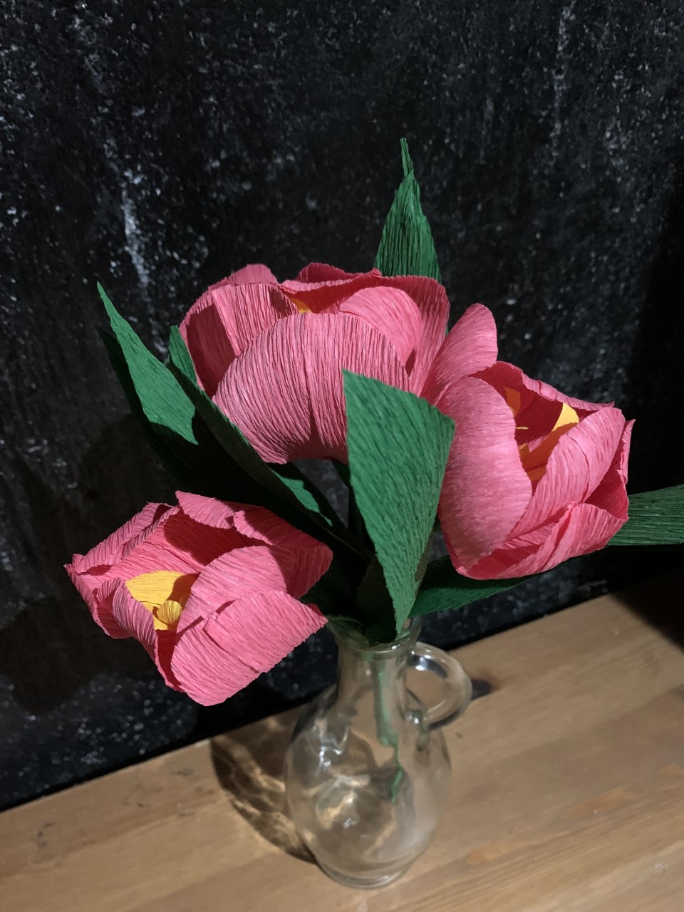 Image of pink tulips with green stems and leaves made from Crepe Paper in a vase.