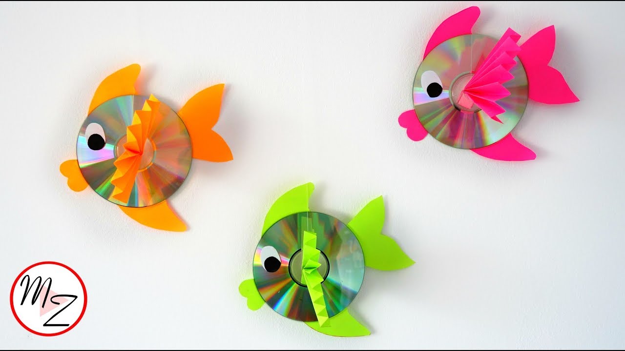 3 fish made out of CD's and cut out colored paper for fins and eyes on a white backdrop. 