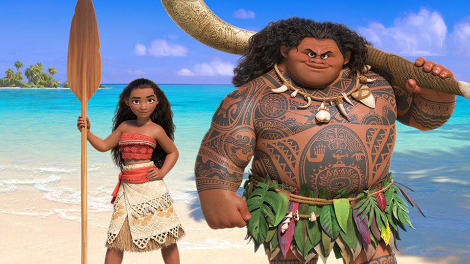 Image of Disney's Moana standing besides Disney's Maui on a beach.
