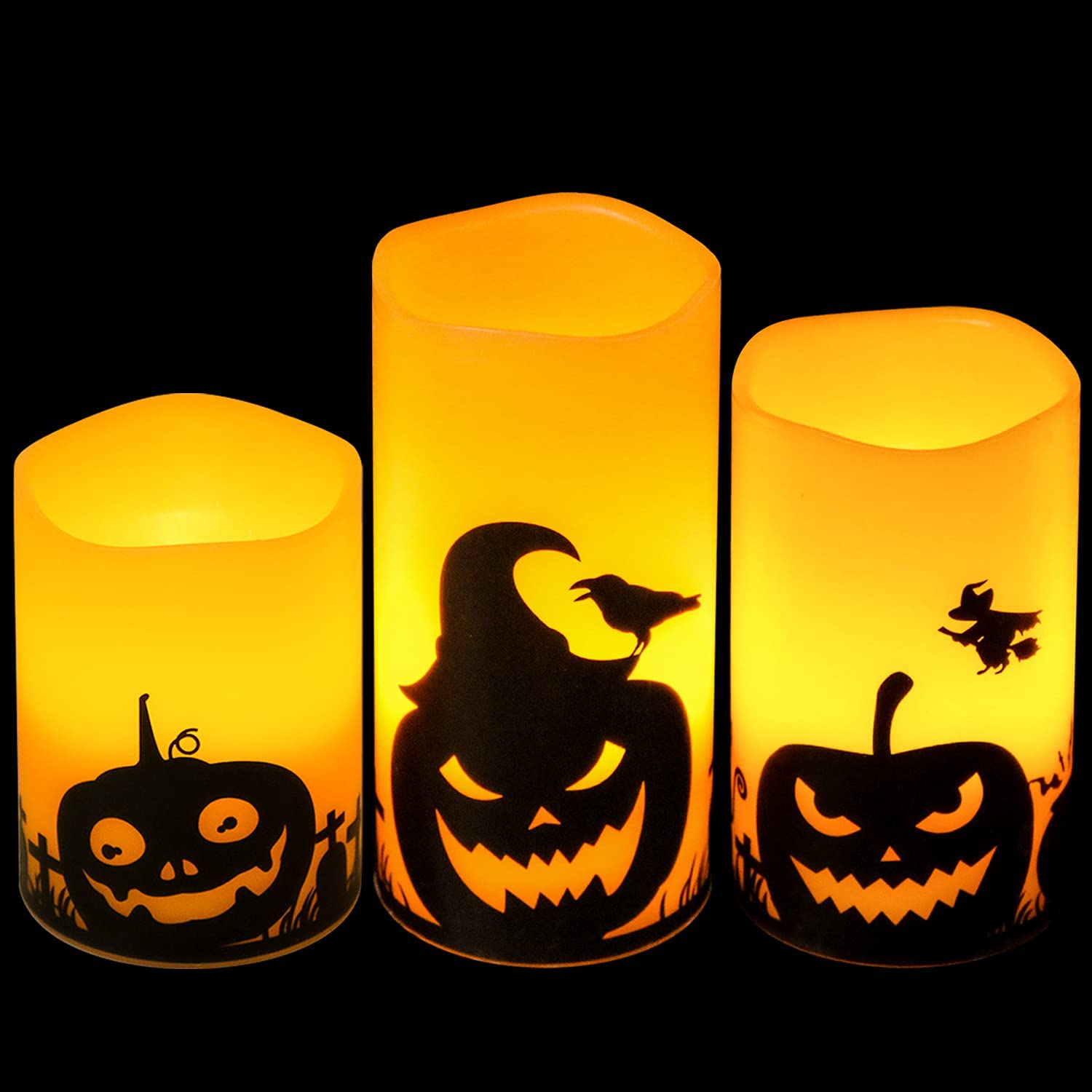 image of 3 halloween themed candles of varying heights with jack-o-lantern silhouettes on them. 