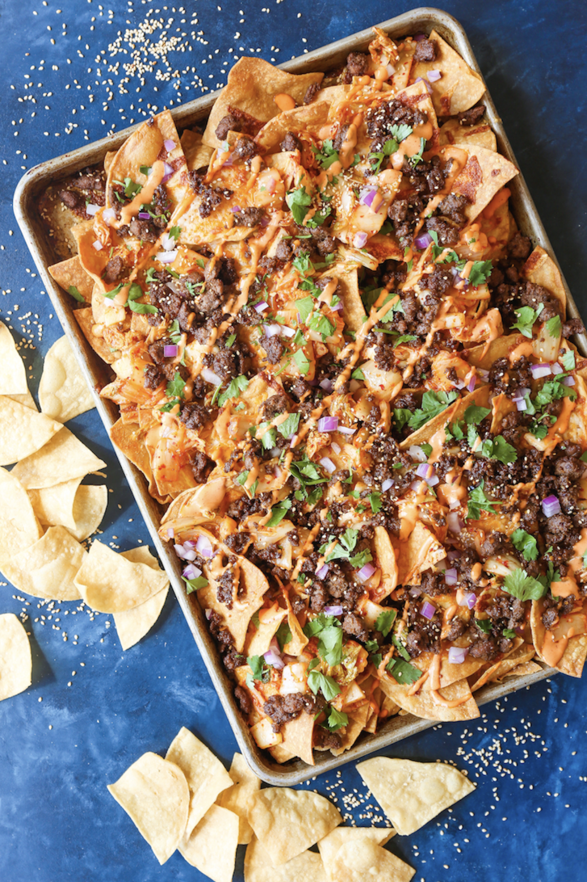 generic image of nachos on a platter over a blue table.