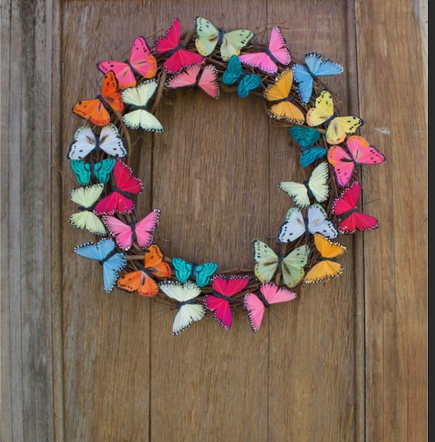 Image of the craft featuring a circle wreath with colorful butterflies attached. 