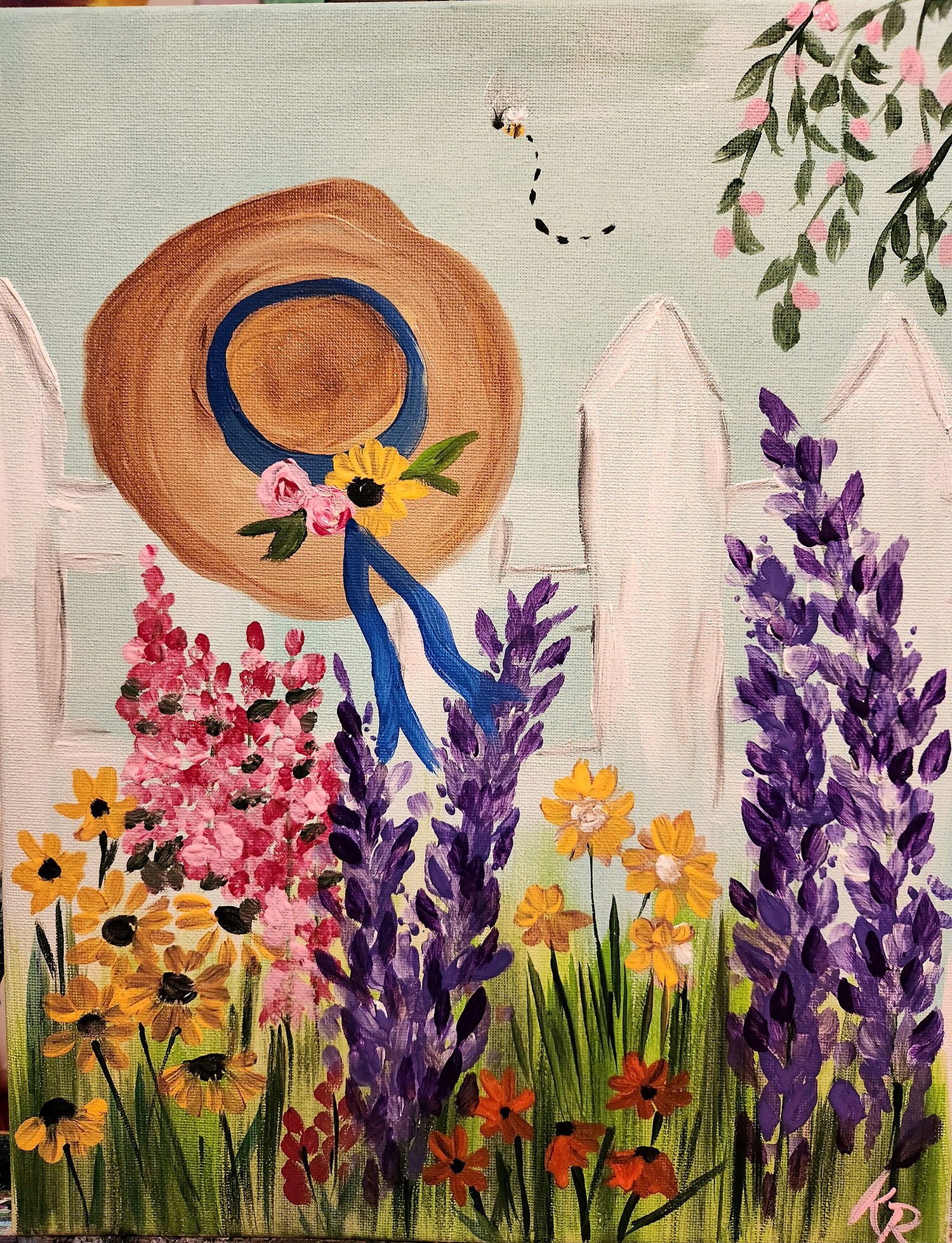 Image of an acrylic painting with flowers and a straw hat with a ribbon hanging on a fence.