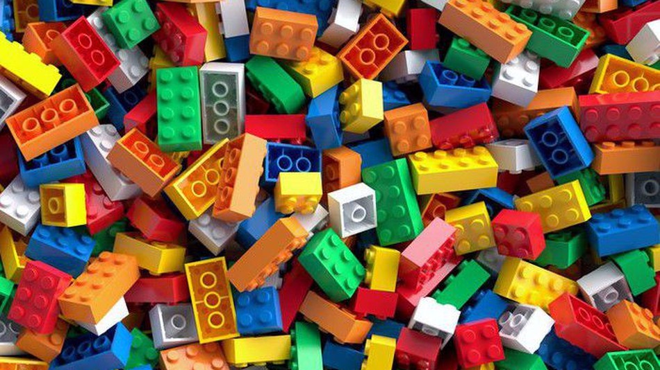 Image of multicolored LEGOs piled atop each other.