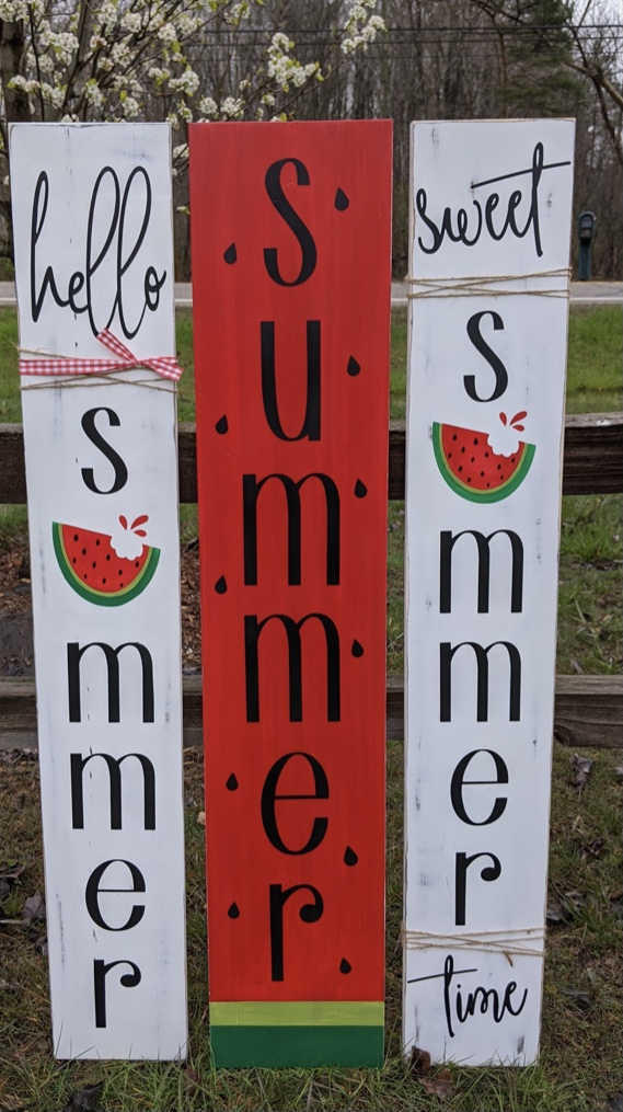 Image of the project, Vertical signs that have Hello Summer painted on them with a painted slice of watermelon.