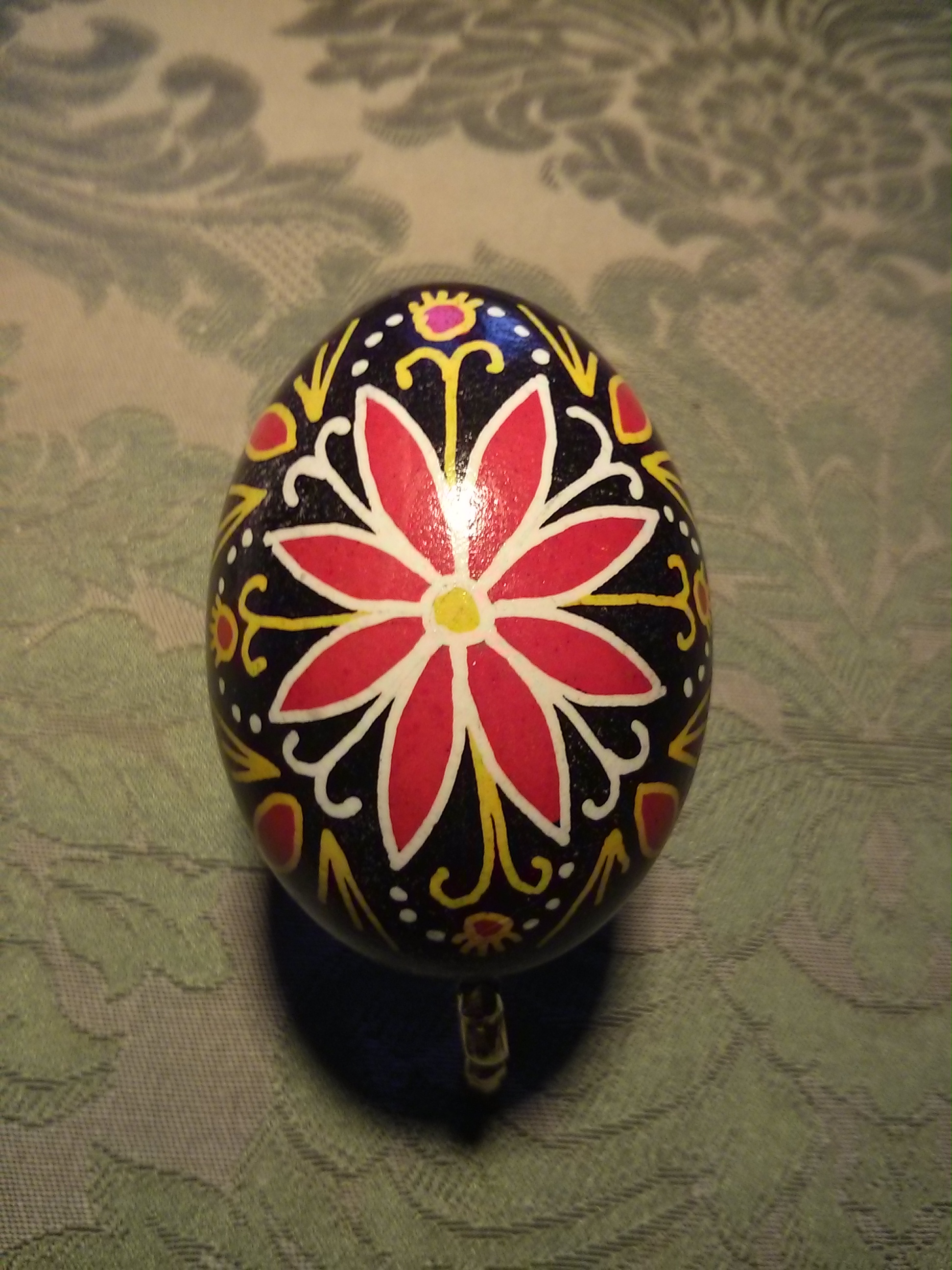 Image of an egg painted with an intricate floral design. 