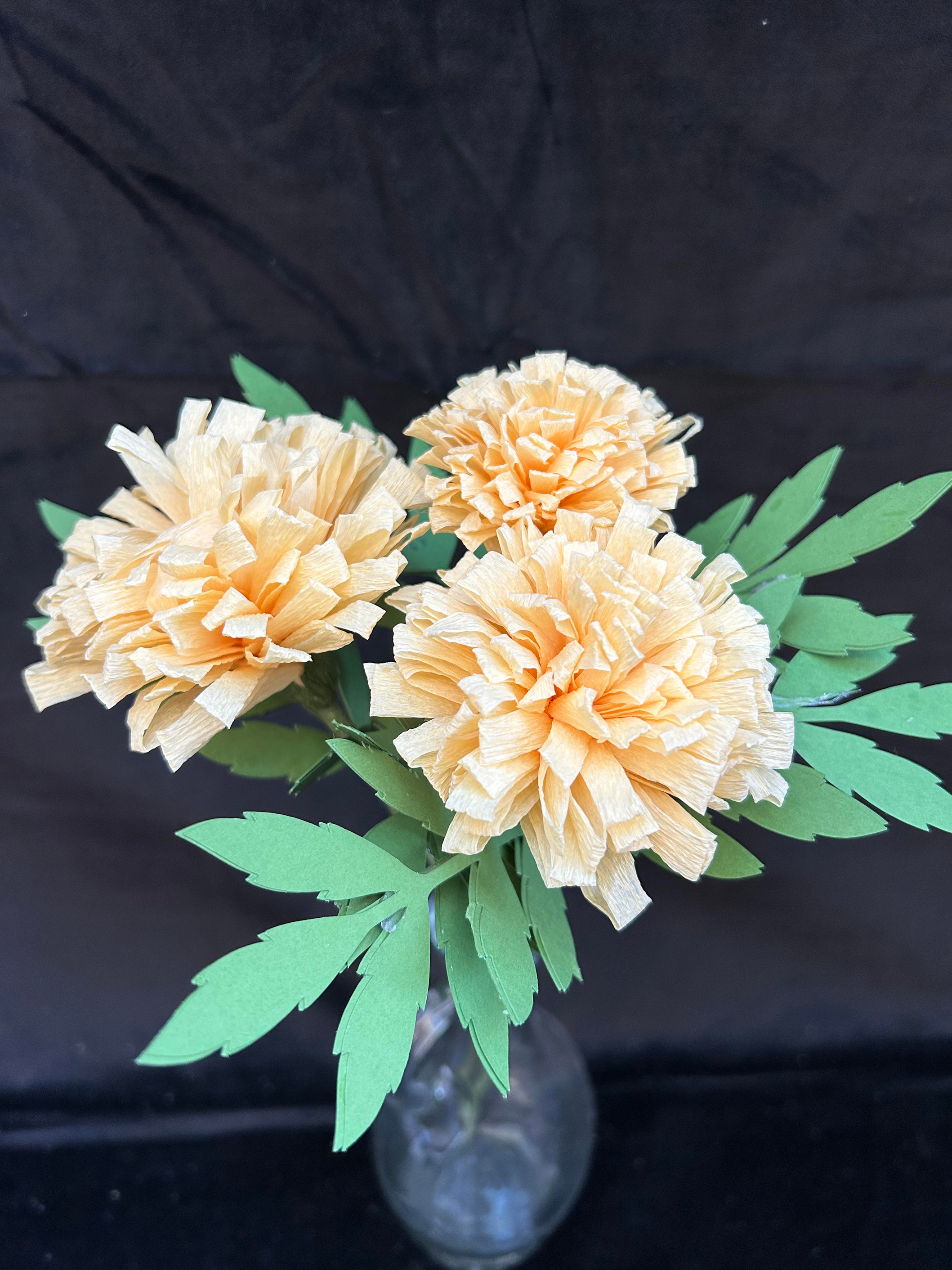 Image of the craft featuring marigold plants made from crepe paper.