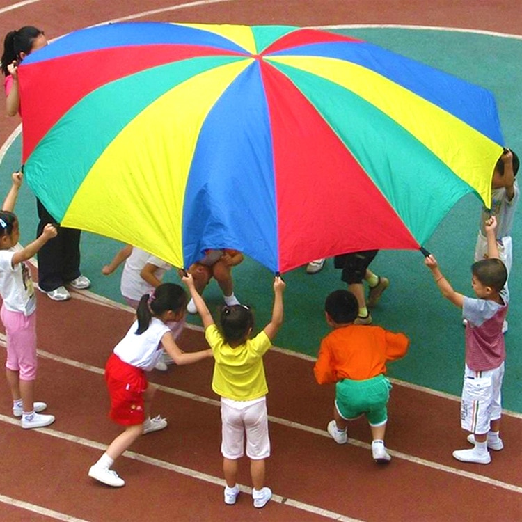 Image of children playing with a multi colored parachute. 