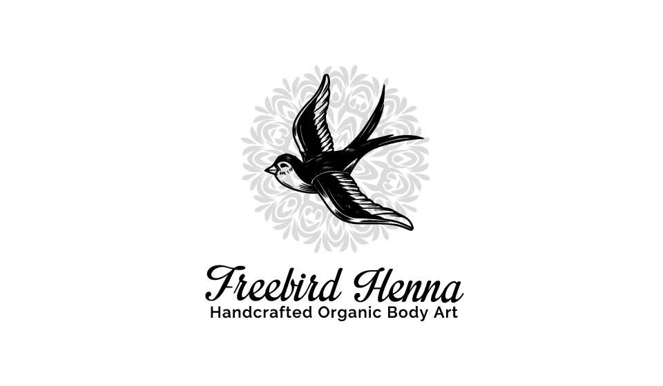 Logo of Freebird Henna, featuring a gray circular design in the shape of a henna artwork, with a black drawn bird over it. Beneath the logo are the words Freebird Henna in script, and beneath that in a smaller font are the words Handcrafted Organic Body Art.