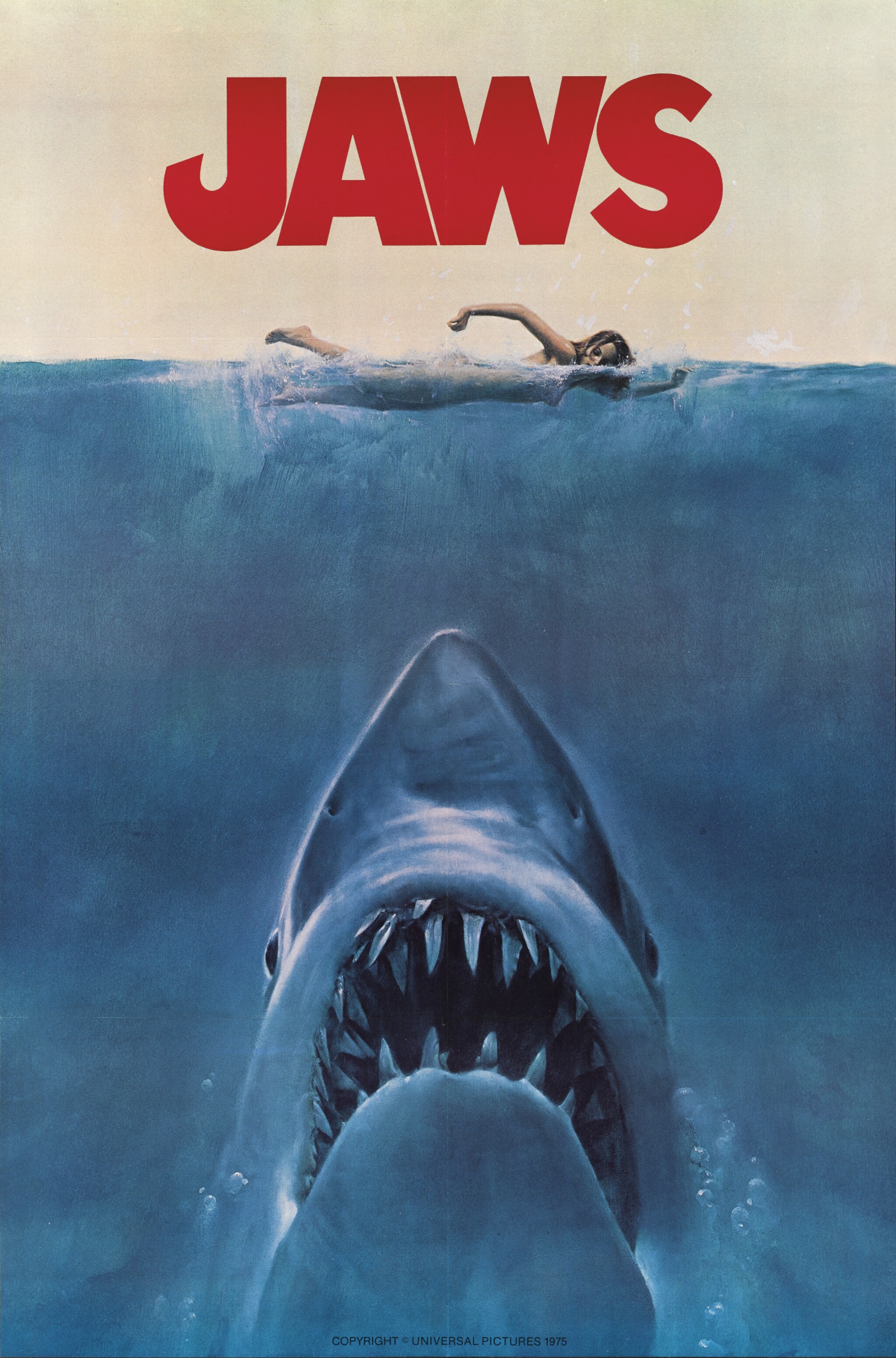 Jaws movie poster depicting a shark facing upward toward a swimmer. The word JAWS is written in red above the diver.