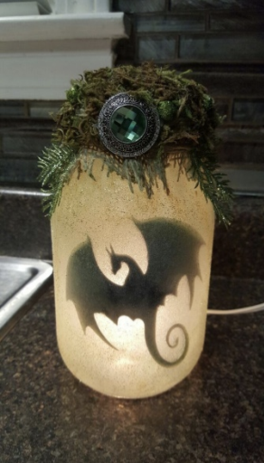 A frosted jar with a dragon silhouette inside. 