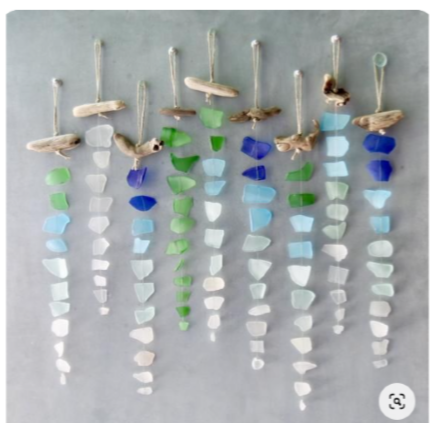 Image of the craft featuring different shades of sea glass on a long string ready to hang. 