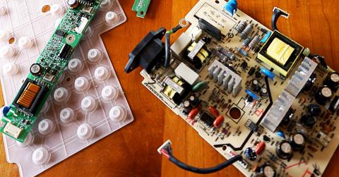 Image of the inside working parts and motherboard of a computer on a table. 