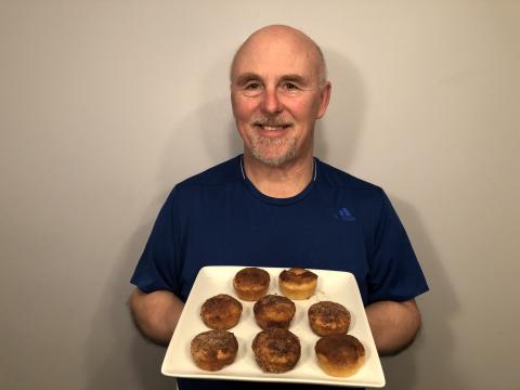 Photo of Rob Scott holding a tray of the churro muffins