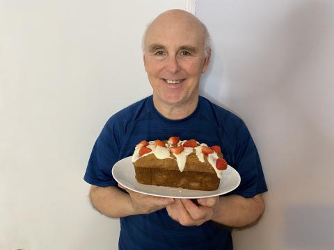 Photo of Rob Scott holding a tray with the strawberry bread. 