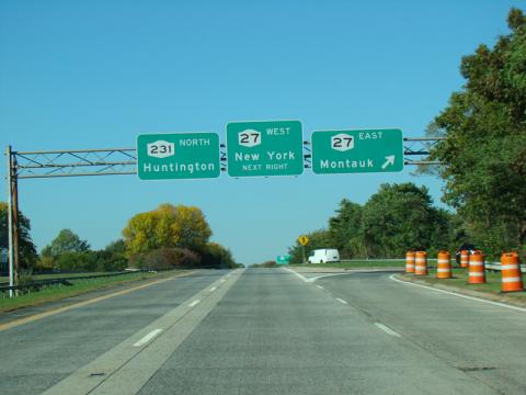 Photograph of road signs that lead guide a driver towards Huntington.