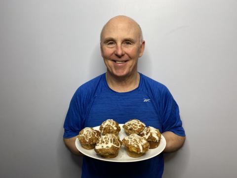 Image of Chef Rob holding Peach Muffins with a Streusel Topping. 