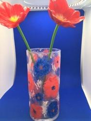 Image of a clear vase with red and blue poppies painted on.