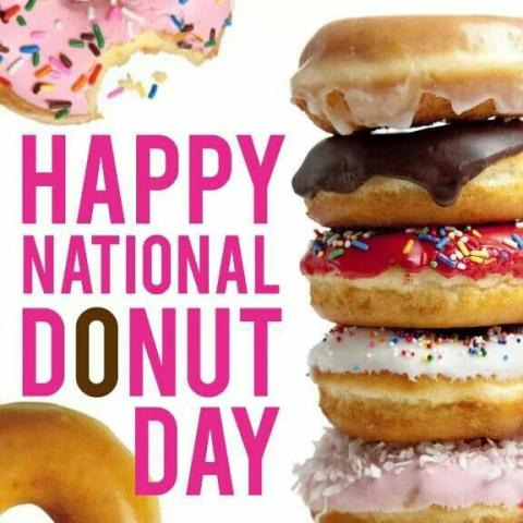 Image of a stack of donuts with different icing colors and sprinkles. The words Happy National Donut Day spelled out.. 