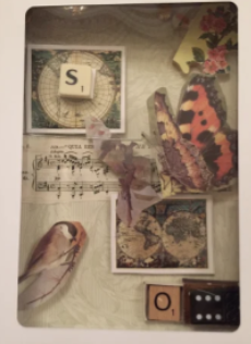 Shadow Box craft which appears to be sentimental objects and scrabble pieces and butterflies pasted inside a clear box.
