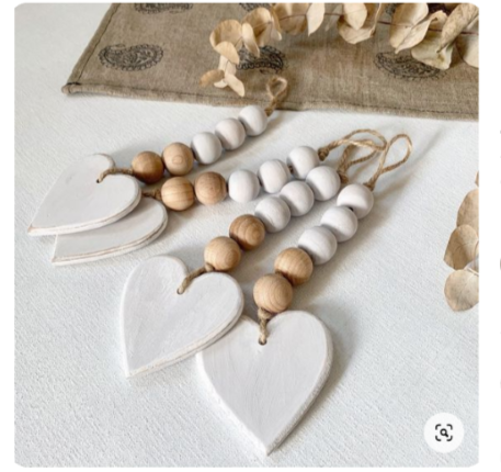 Image of the craft featuring a keychain made out of wooden beads and a wooden heart at the end of the chain.