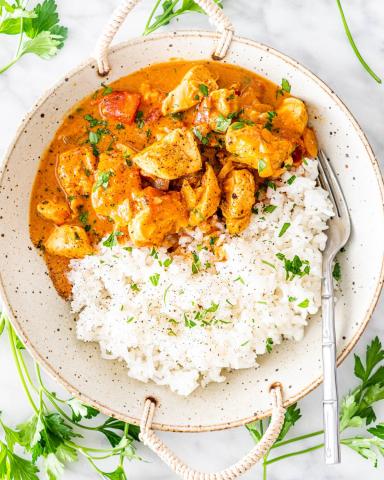 Chicken Curry and Rice in a bowl with a fork on the right.