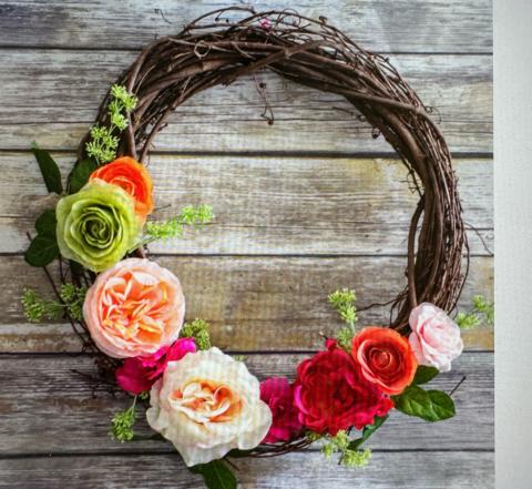 Image of the craft featuring a wreath made of dark wood vines with colorful flowers.