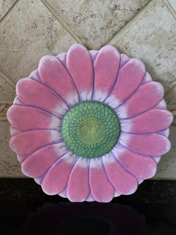 Image of the craft featuring a ceramic plate shaped like a daisy and colorfully painted.