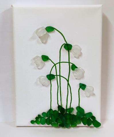 Image of flowers with stems formed by sea glass and glued onto a canvas