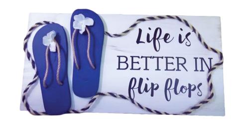 Image of the craft featuring a pair of flip flops on a painted board with decoration and wording stating that life is better in flip flops. 
