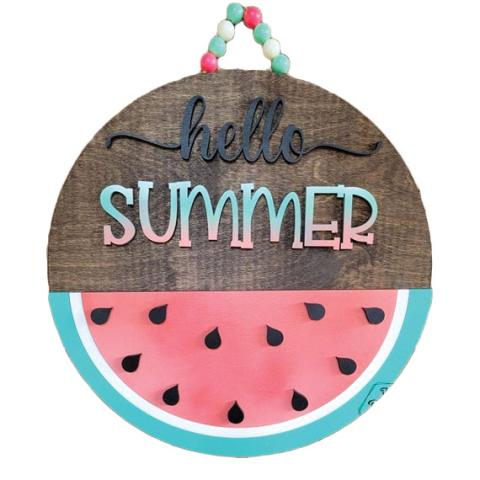 Round sign painted to look like a watermelon slice with the words "hello summer"
