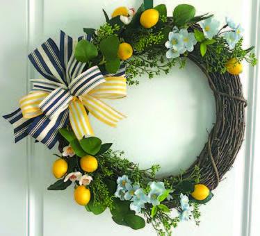 Image of the craft featuring different dried flowers creating a round wreath with a bow