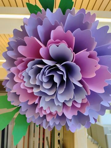 Image of the craft featuring a flower with many petals made from paper.