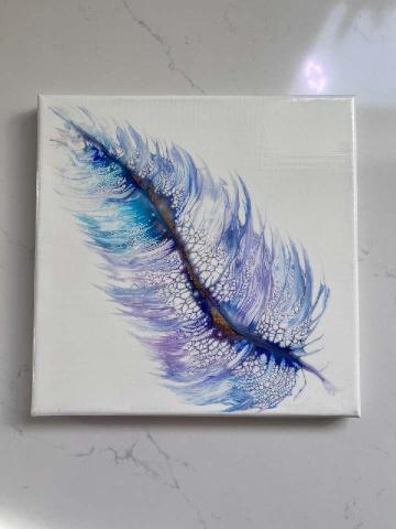 Image of the craft featuring a painted feather on a tile. 