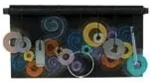 Black sculpture with multicolored musical symbols on it.